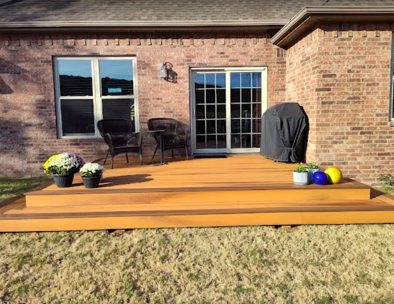 Lifestyle entertaining deck with brick home and flowers — JHG Contracting LLC serving Summers, AR