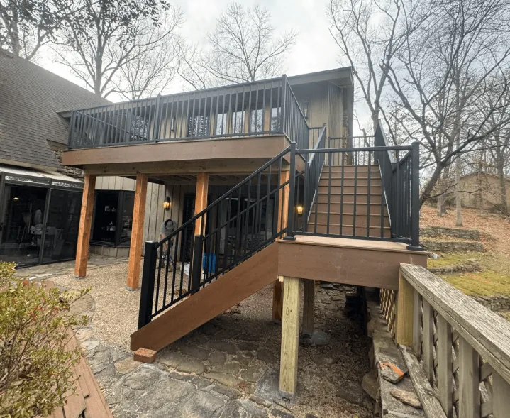 Elevated composite deck with black metal railings and stairs near Fayetteville AR — JHG Contracting LLC