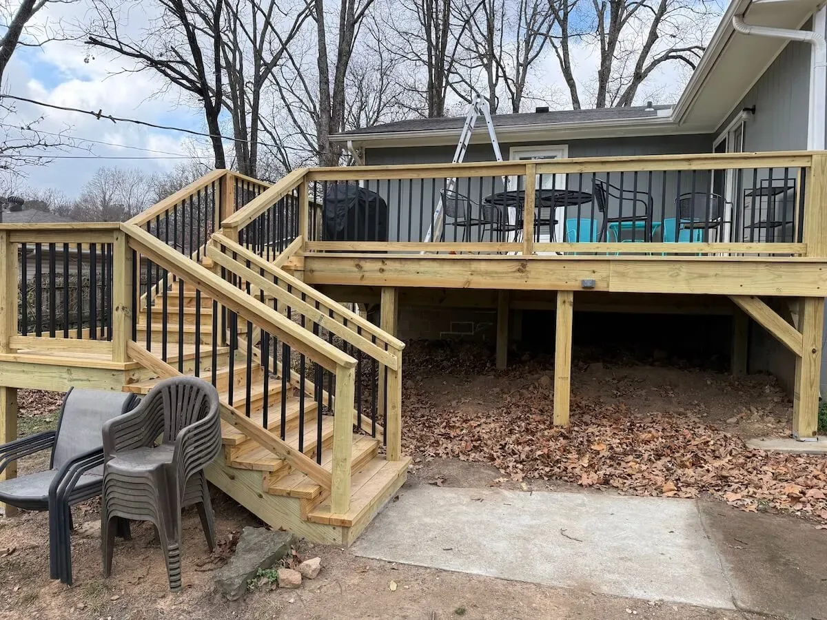 Multi-level wood deck with black balusters and stairs — JHG Contracting LLC serving Gentry, AR